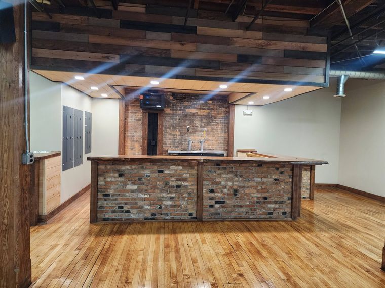 The reclaimed-brick bar under its timber canopy
