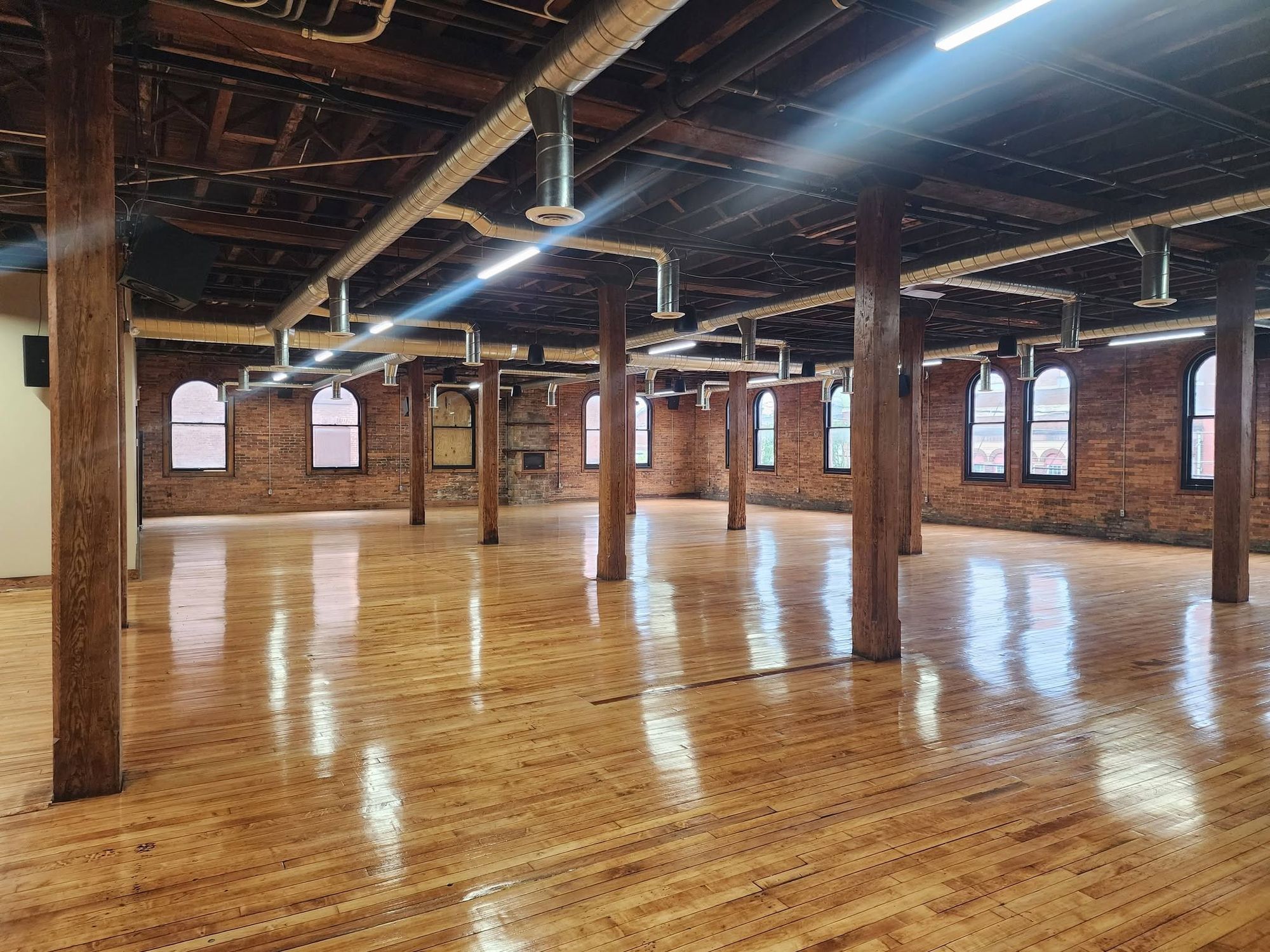 Afternoon light across the hall's original hardwood floor