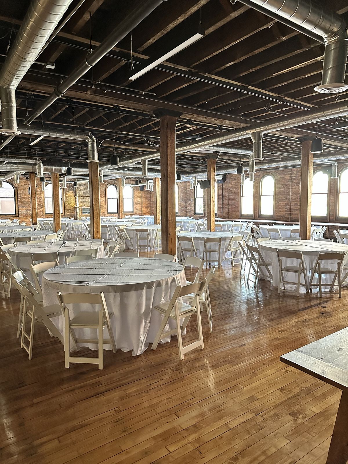 Round tables set between the hall's timber posts